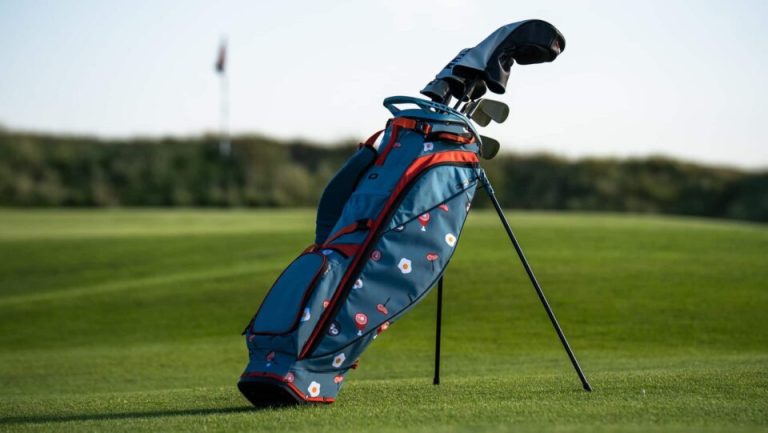 OGIO Ham and Eggs stand golf bag positioned on a golf course fairway with built in stand legs