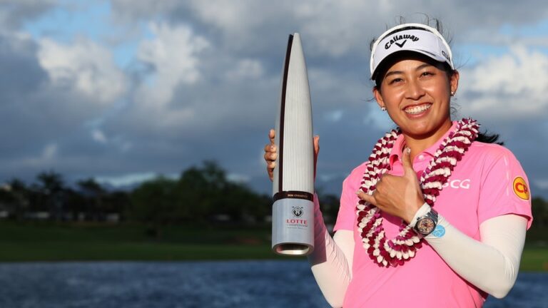 Jeeno Thitikul of Thailand poses with the trophy after her winning birdie putt on the 18th green during the final round of the LOTTE Championship